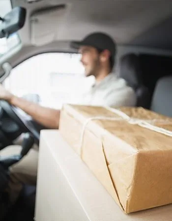 Delivery driver with packages in vehicle.